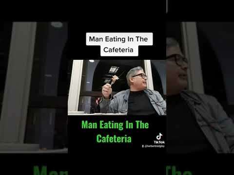 Man Eating In The Cafeteria